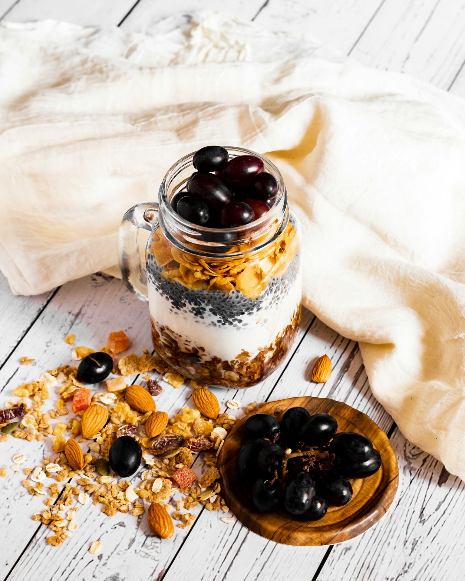 a glass jar filled with granola and black olives